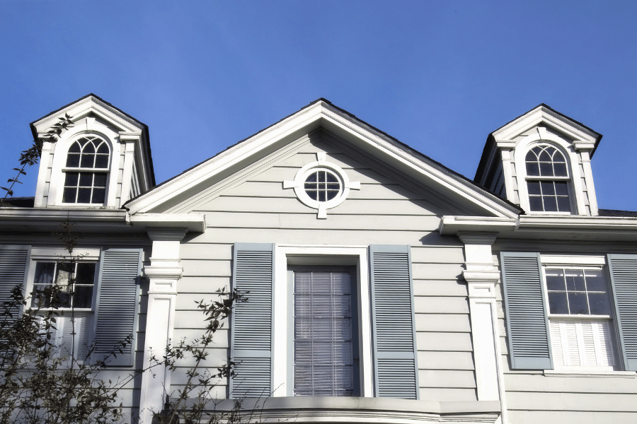 Upper half of Colonial Style Home with light blue shutters