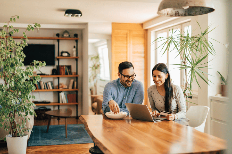 cute couple looking at homes for sale online 