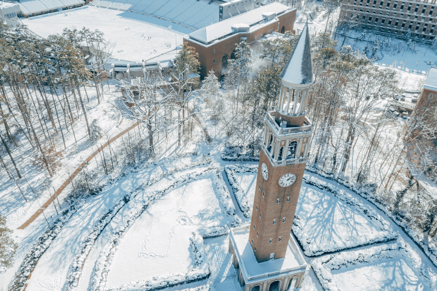 Aerial view of UNC Campus in the snow with the football stadium in the background