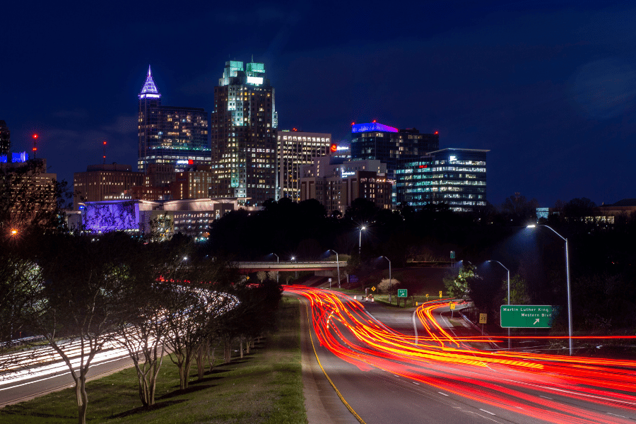 Downtown Raleigh view from the road with lights in the dark