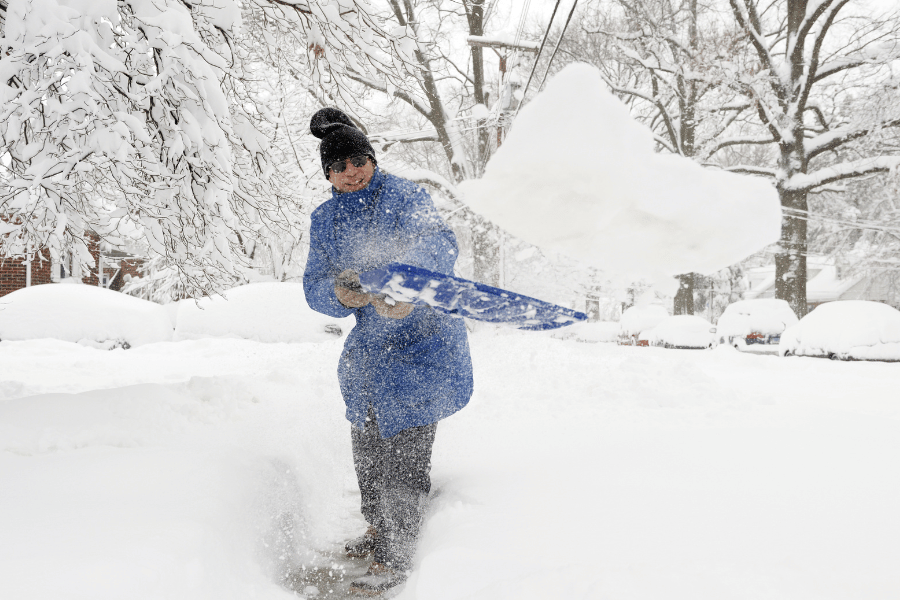 Shoveling snow at home during winter storm