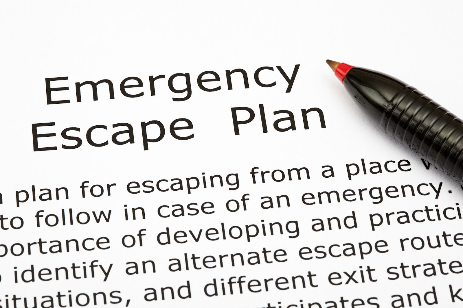 A pen lays on top of a document that reads “Emergency Escape Plan.