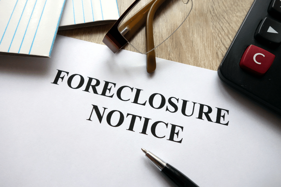 foreclosure notice with pen and glasses 