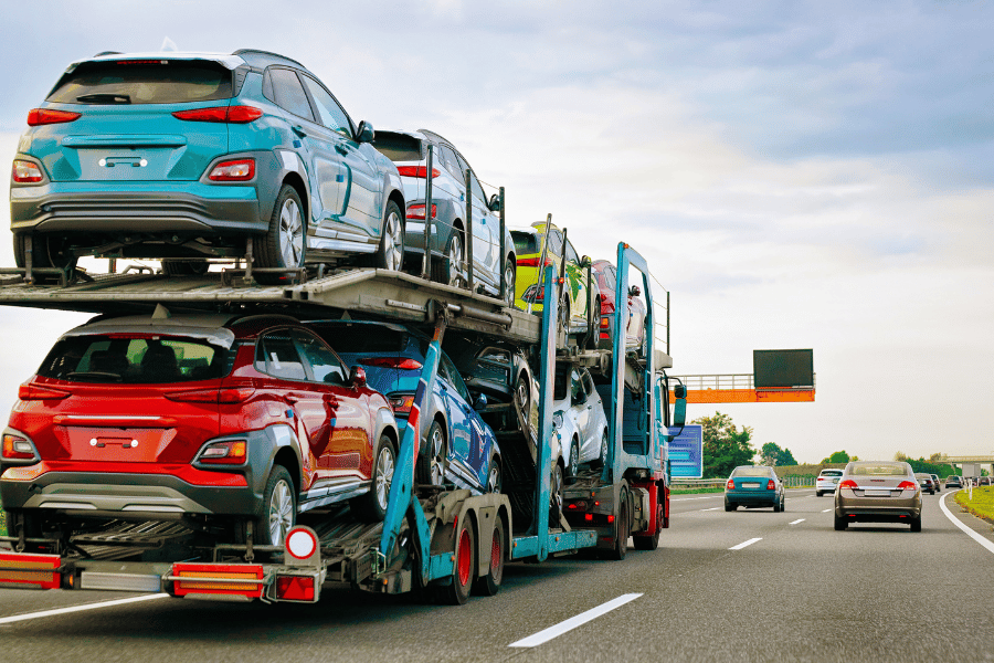 car carrier truck driving cars cross-country on the highway