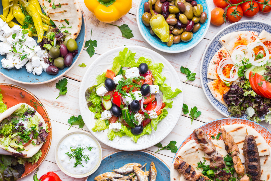 Spread of Greek food on a white background