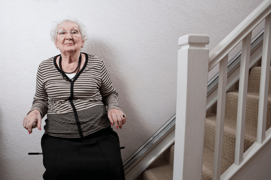 woman on a star lift at home to go up the stairs 