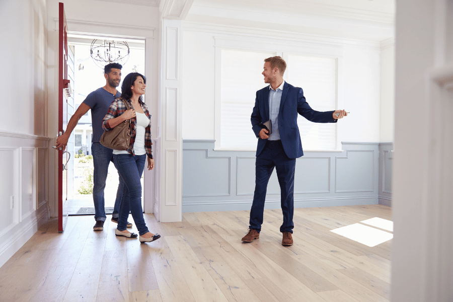 couple at a home showing with a real estate agent