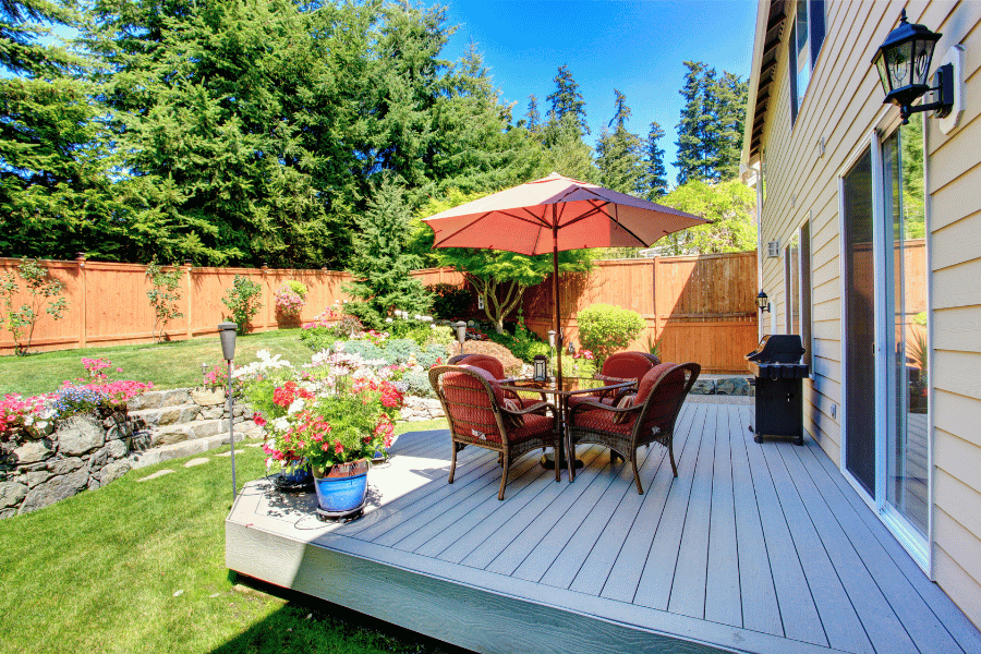 Beautiful backyard patio area with plants and table