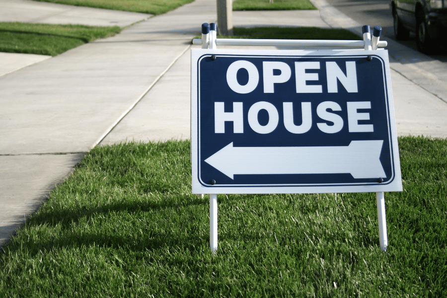Open house sign in a front yard for potential home buyers