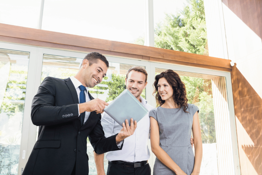 successful real estate agent working with clients 