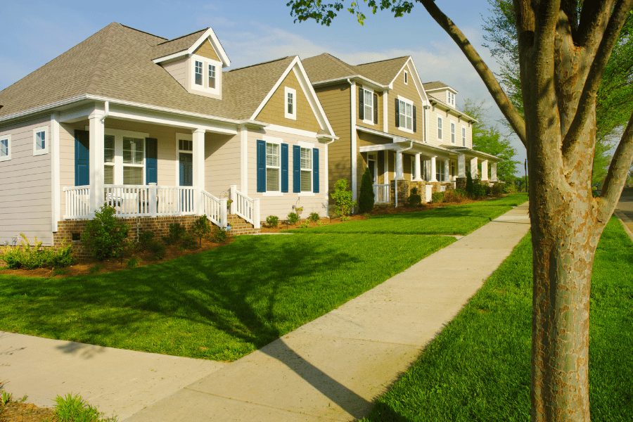 Quiet neighborhood street with beautiful homes and freshly cut grass