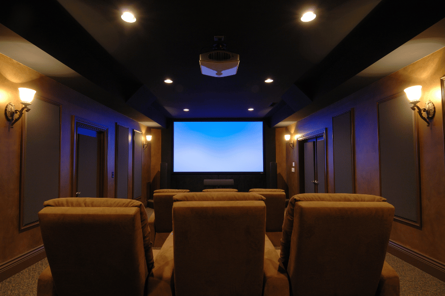 home movie theater with comfortable chairs and movie screen