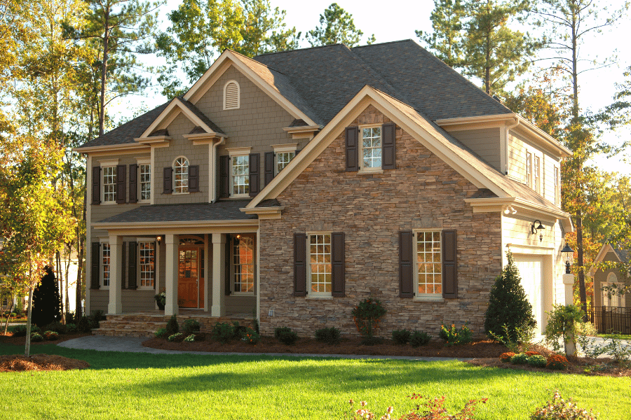 suburban home in a residential district with stone and black shutters