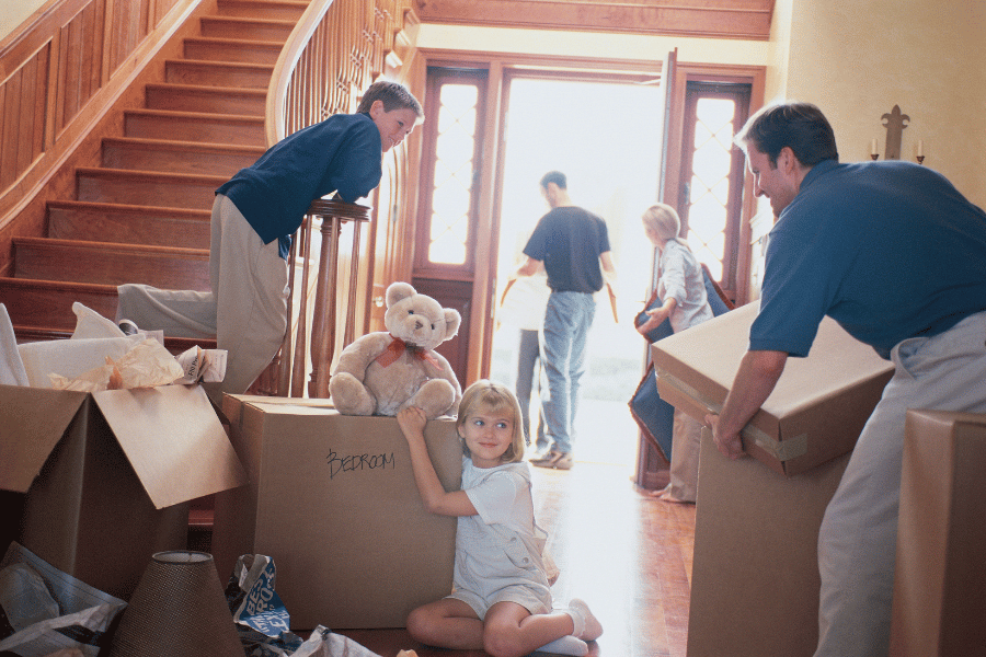 family packing all of belongings into boxes and moving out of house